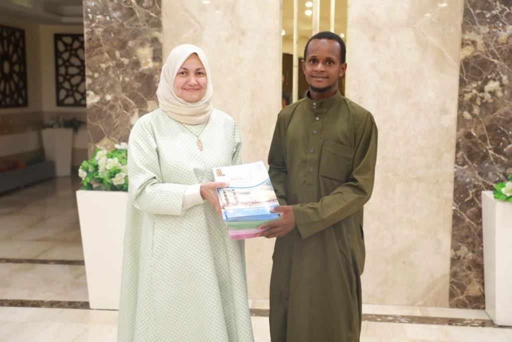 Mamadou Safayou Barry, a Guinean student, who cycled from his home country to Egypt to study at Al-Azhar Al-Sharif, with Dr. Nahla Elseidy, adviser for expatriate affairs at the university. (Supplied)