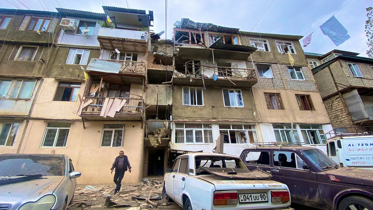 A view shows a damaged residential building and cars following the launch of a military operation by Azerbaijani armed forces in Nagorno-Karabakh. (Reuters)