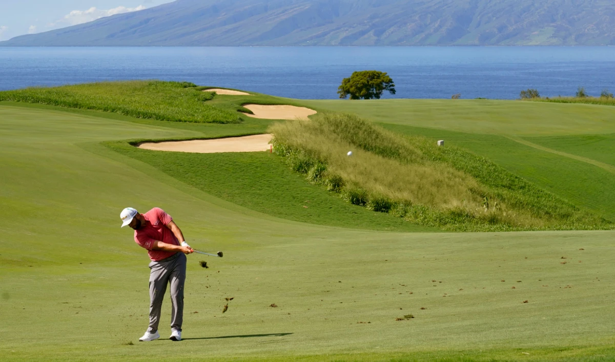Jon Rahm, of Spain, hits from the 13th fairway during the final round of the Tournament of Champions on Jan. 9, 2022, at Kapalua Plantation Course in Kapalua, Hawaii. The PGA Tour says the tournament will return to Kapalua on Maui five months after the deadly wildfires. (File/AP)