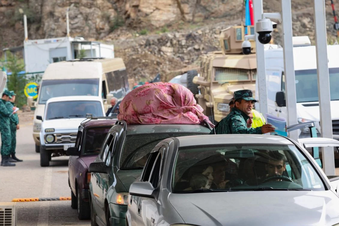 This photograph taken on September 26, 2023, at the Lachin checkpoint shows Armenian waiting in their cars at the border crossing station. (AFP)