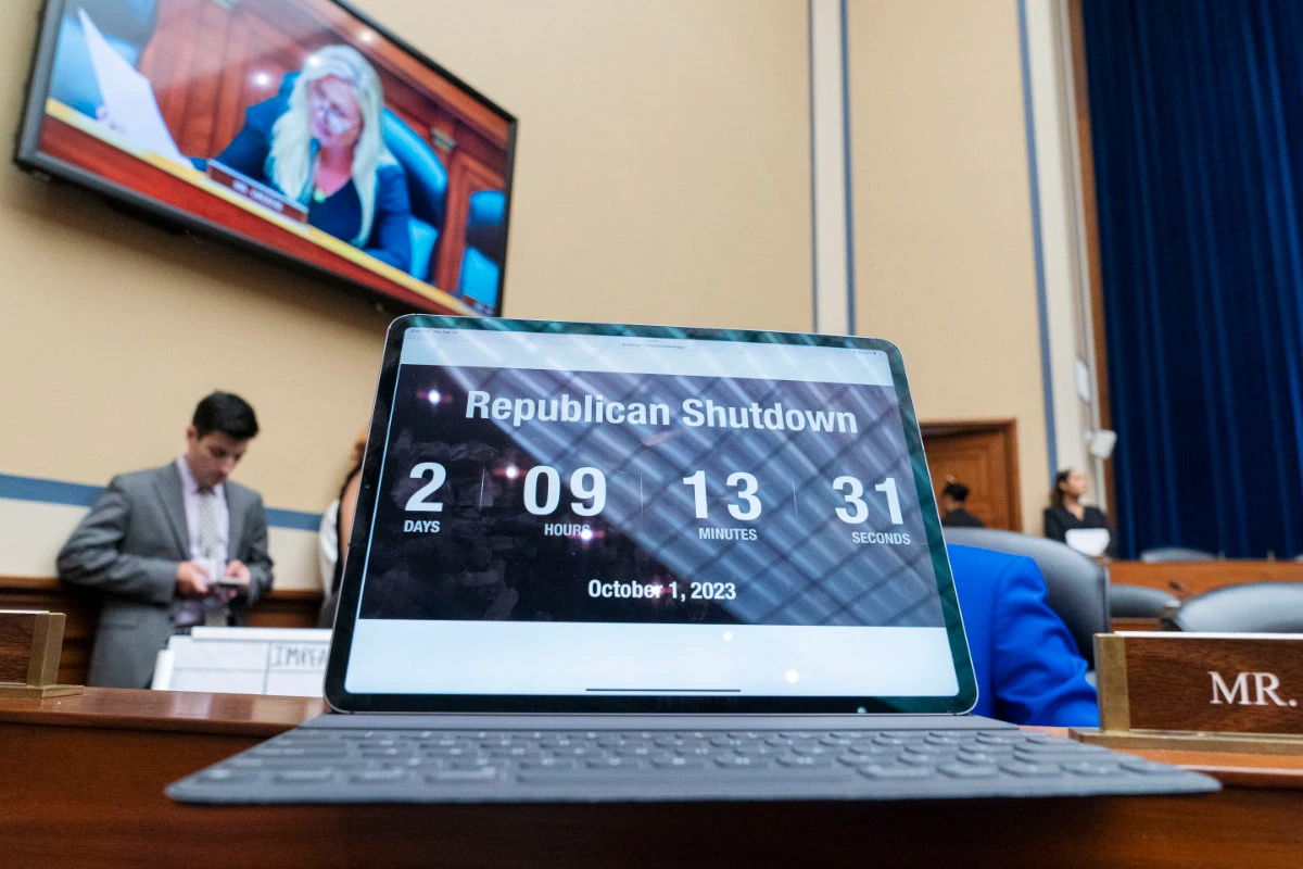 A countdown clock about the time left before a government shutdown is seen in the foreground as Rep. Marjorie Taylor Greene is seen on a screen during a House Oversight Committee impeachment inquiry into President Joe Biden on Sept. 28, 2023, in Washington. (AP)