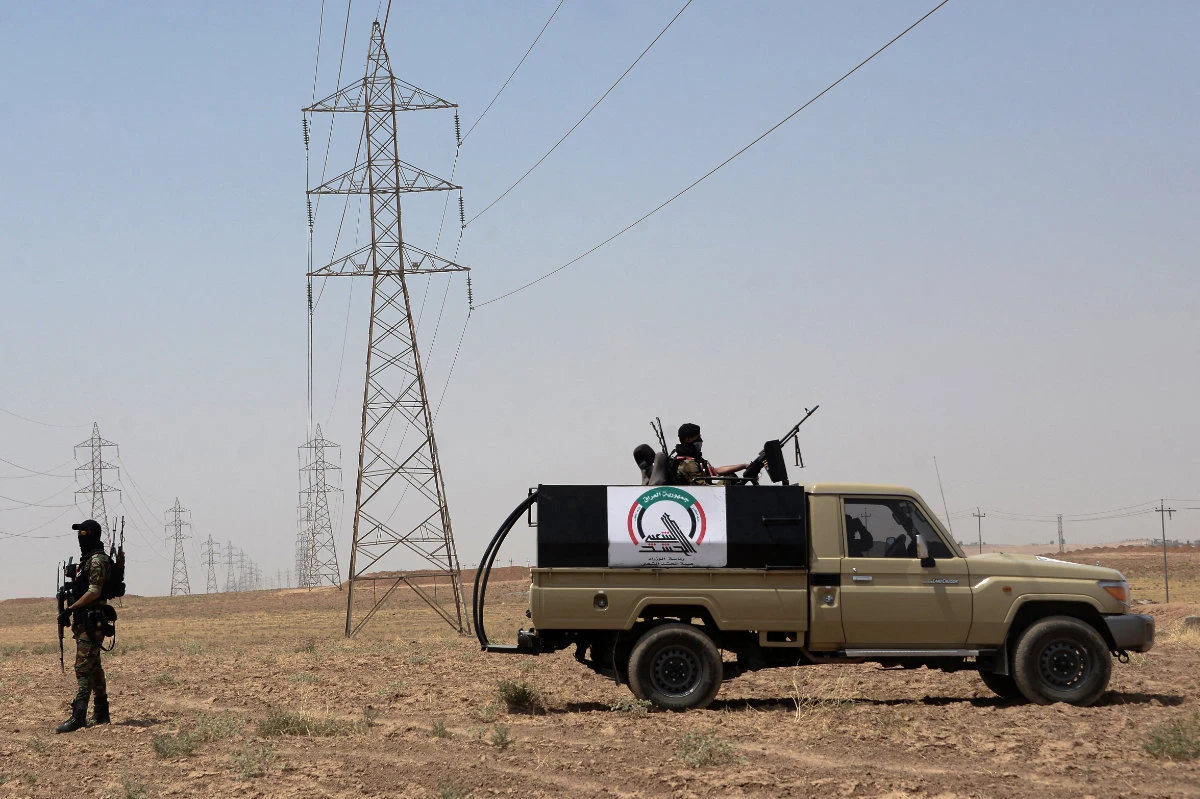 Hashd al-Shaabi militia members control a large part of Iraq, including parts of Niniveh governorate. (AFP/File)