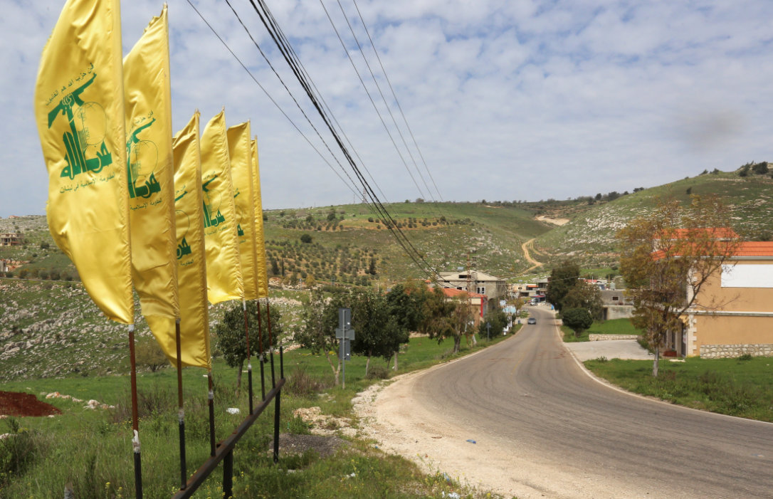 Hezbollah flags flutter along an empty street at the entrance of Mays Al-Jabal village, Lebanon. (Reuters/File)