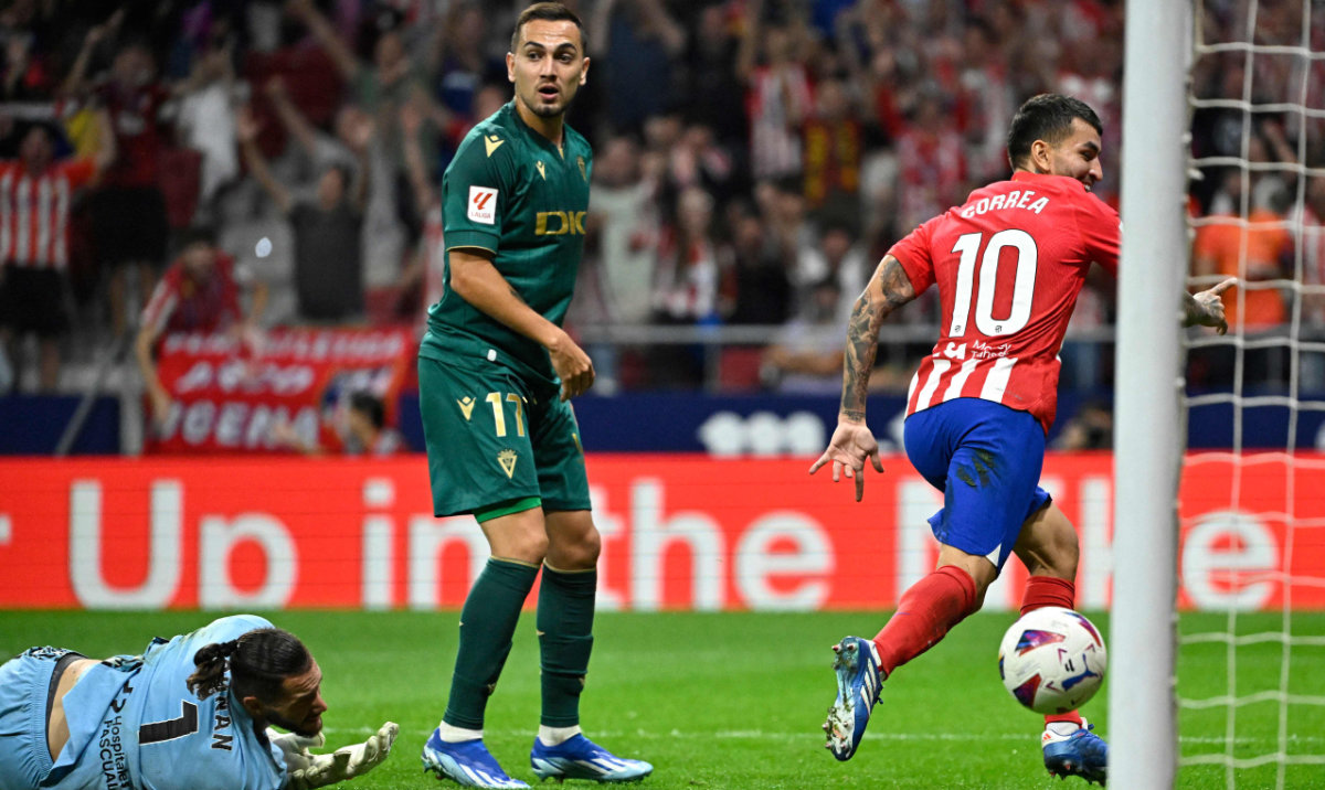 Atletico Madrid's Argentinian forward Angel Correa (R) celebrates scoring his team's third goal during the Spanish Liga football match between Club Atletico de Madrid and Cadiz CF at the Metropolitano stadium in Madrid on Sunday. (AFP)