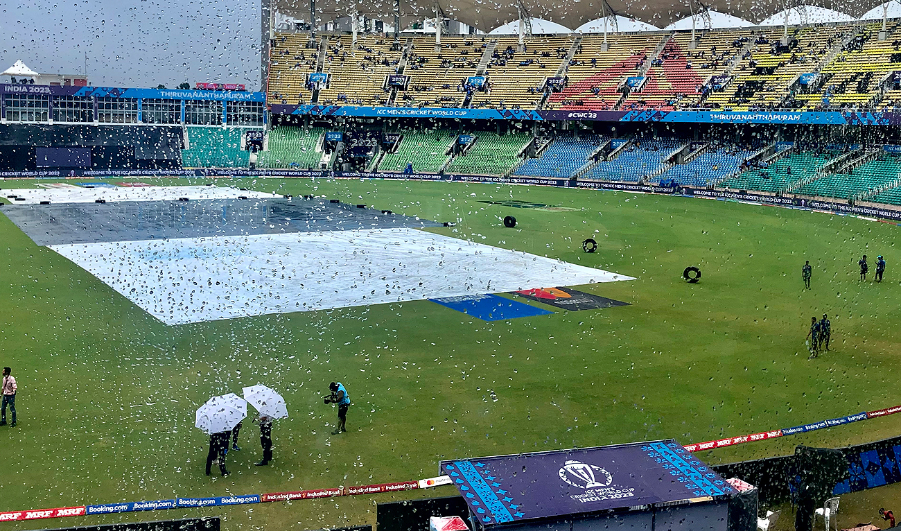 Umpires assess the ground as rain delays play during the ICC Cricket World Cup cricket match between India and Netherlands in Thiruvananthapuram, India on October 3, 2023. (AP)