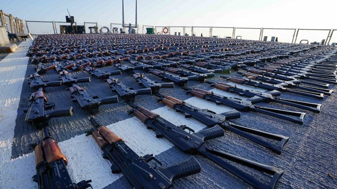 Thousands of AK-47 assault rifles are seen on the flight deck of guided-missile destroyer USS The Sullivans during an inventory process, after they were seized from a fishing vessel in international waters of the Gulf of Oman in December 2022. Also seized were more than a million rounds of bullets. (US Navy via AFP/File)