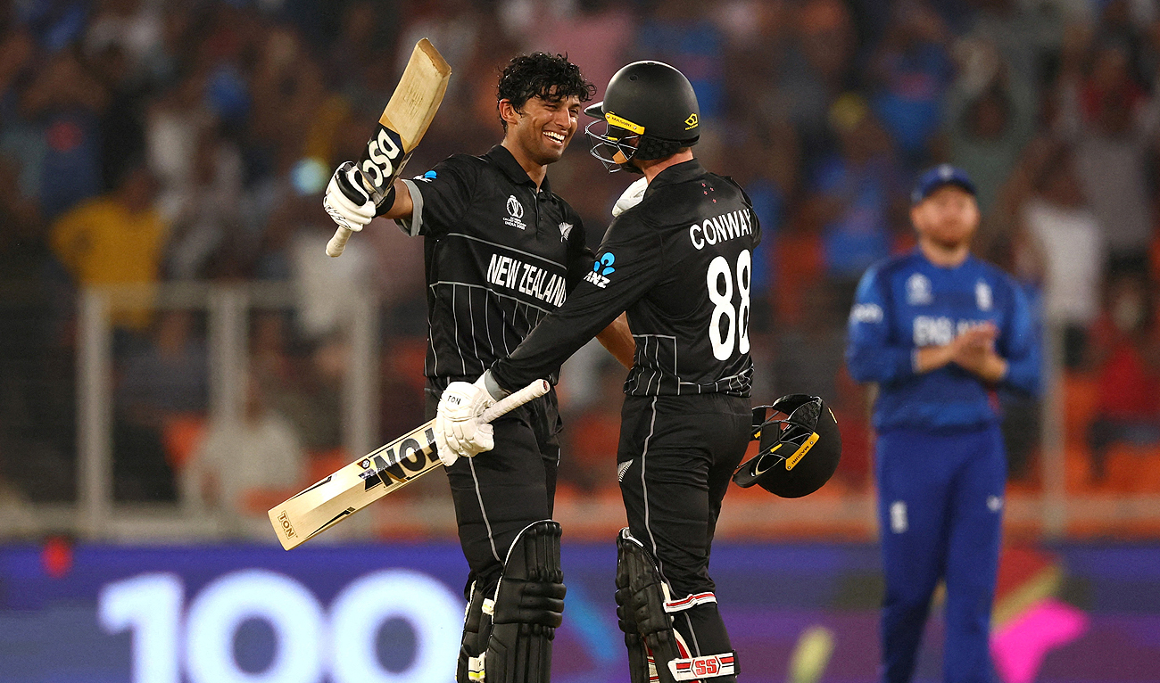 New Zealand's Rachin Ravindra celebrates after reaching his century with Devon Conway during the ICC Cricket World Cup opening match against England in Ahmedabad, India on October 5, 2023. (REUTERS)