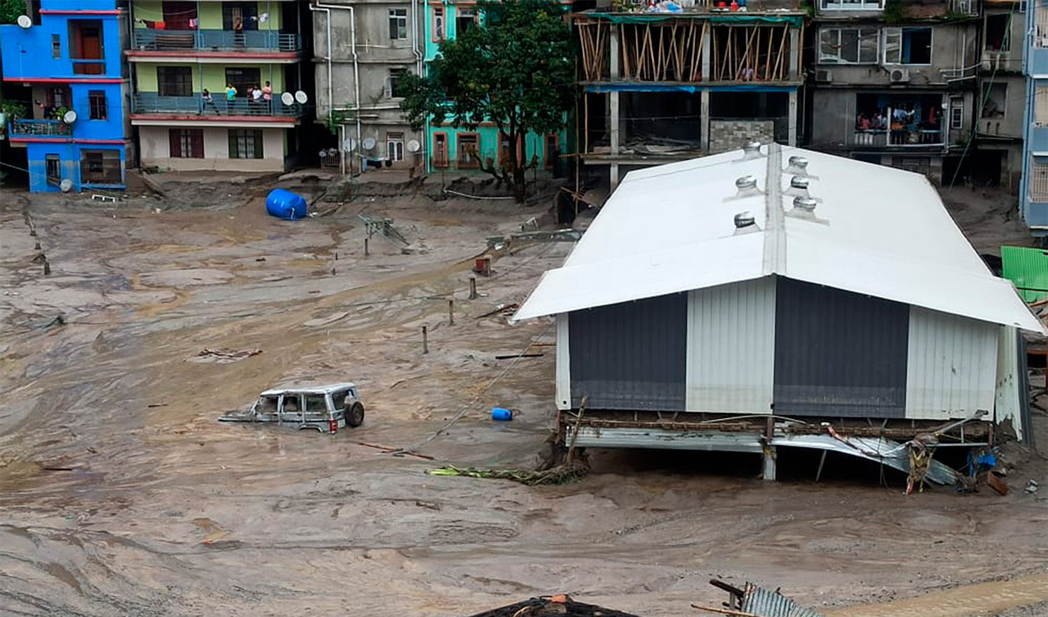 A vehicle is seen partially submerged in water after flash floods triggered by a sudden heavy rainfall swamped the Rangpo town in Sikkim, India, on October 5, 2023. (AP)