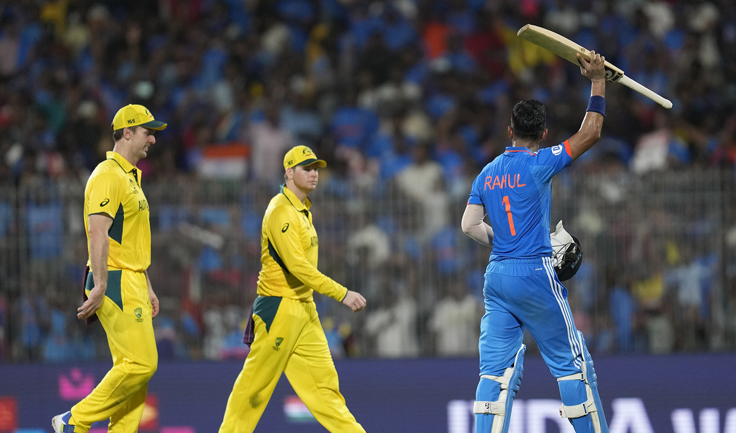 India's KL Rahul, right, raises his bat as he acknowledges the crowd after winning the ICC Cricket World Cup match against Australia in Chennai, India, on October 8, 2023. (AP)