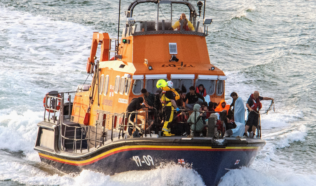 Migrants picked up at sea while attempting to cross the English Channel, are brought by a UK Royal National Lifeboat Institution (RNLI) lifeboat into the Marina in Dover, southeast England, on August 12, 2023. (AFP/File)