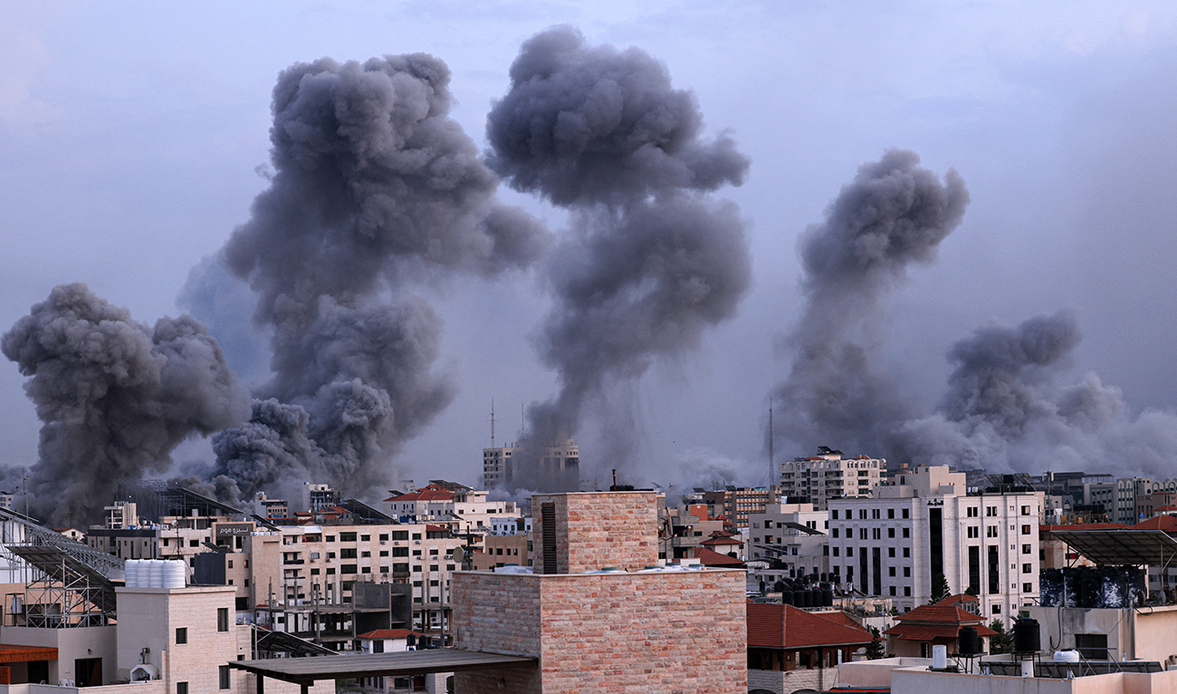 Smoke billows behind highrise buildings during an Israeli airstrike on Gaza City on October 9, 2023. (AFP)