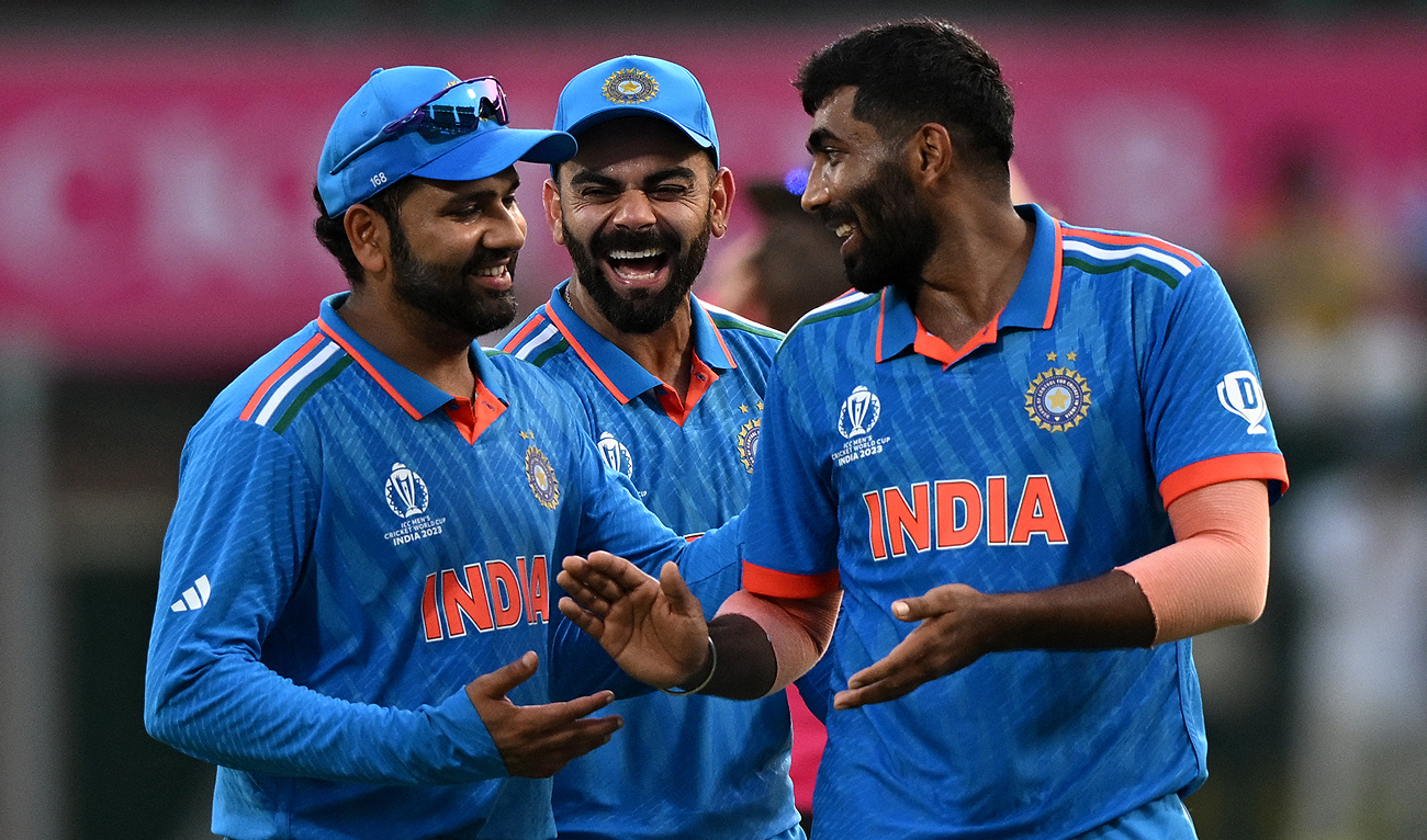 India's Jasprit Bumrah (R) celebrates with teammate Virat Kohli (C) and captain Rohit Sharma after taking the wicket of Australia's captain Pat Cummins during the 2023 ICC Men's Cricket World Cup one-day international (ODI) match between India and Australia at the MA Chidambaram Stadium in Chennai on October 8, 2023. (AFP)