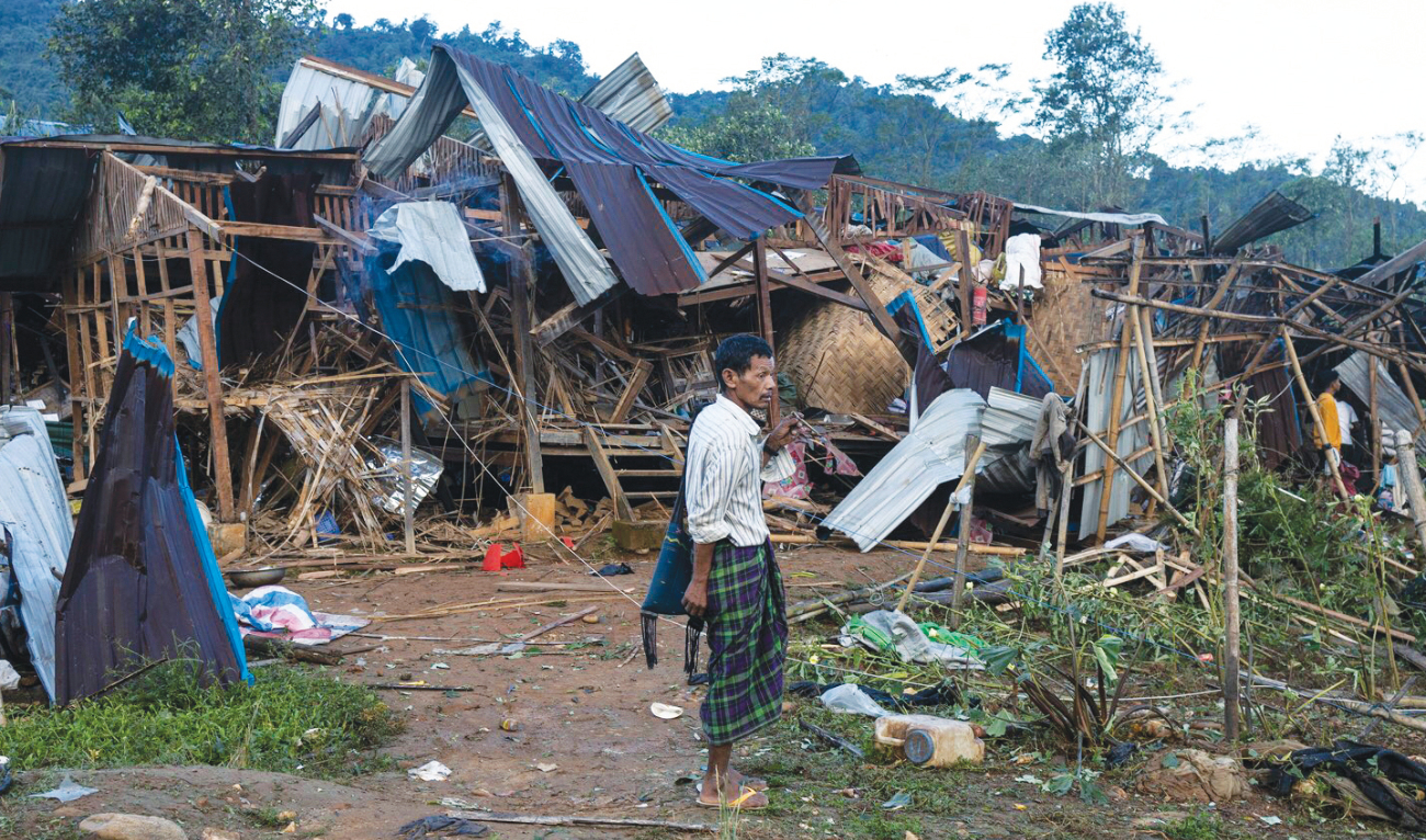 A man looks on at homes destroyed after air and artillery strikes in Mung Lai Hkyet displacement camp, in Laiza, Myanmar on Tuesday. (AP)
