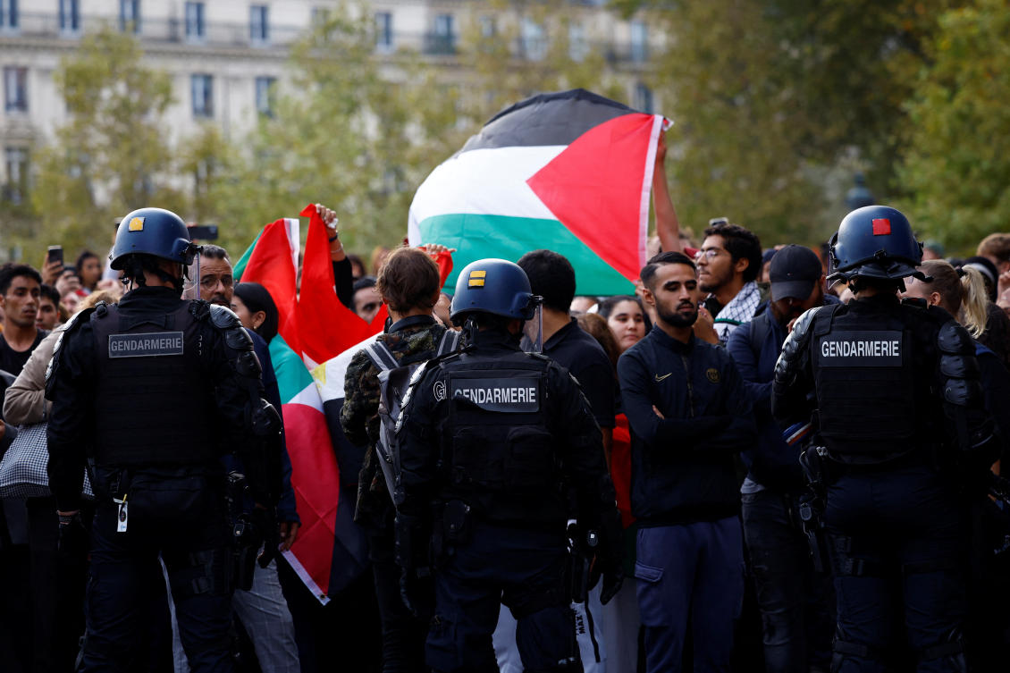 French gendarmes surround protestors holding Palestinian flags during an unauthorized demonstration in support of Palestinians at Place de la Republique in Paris on Oct. 12, 2023. (Reuters)