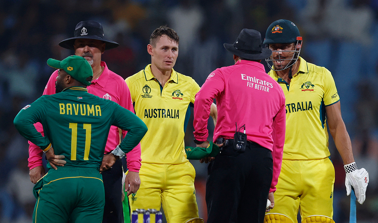 Australia's Marcus Stoinis (right) speaks to the umpire after losing his wicket, caught by South Africa's Quinton de Kock off the bowling of Kagiso Rabada, as Marnus Labuschagne looks during the ICC Cricket World Cup match between Australia and South Africa in Lucknow on October 12, 2023. (REUTERS)