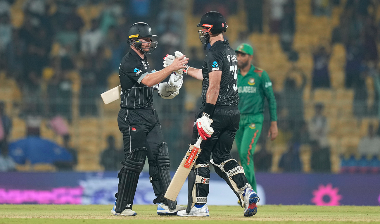 New Zealand's Glenn Phillips ,left, along with New Zealand's Daryl Mitchell celebrate their win against Bangladesh in the ICC Men's Cricket World Cup match in Chennai, India, on October 13, 2023. (AP)