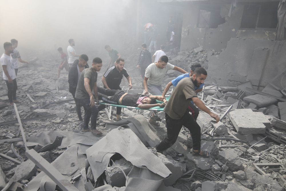 Palestinians evacuate wounded after an Israeli airstrike in Rafah refugee camp, southern Gaza Strip, Thursday, Oct. 12, 2023. (AP)
