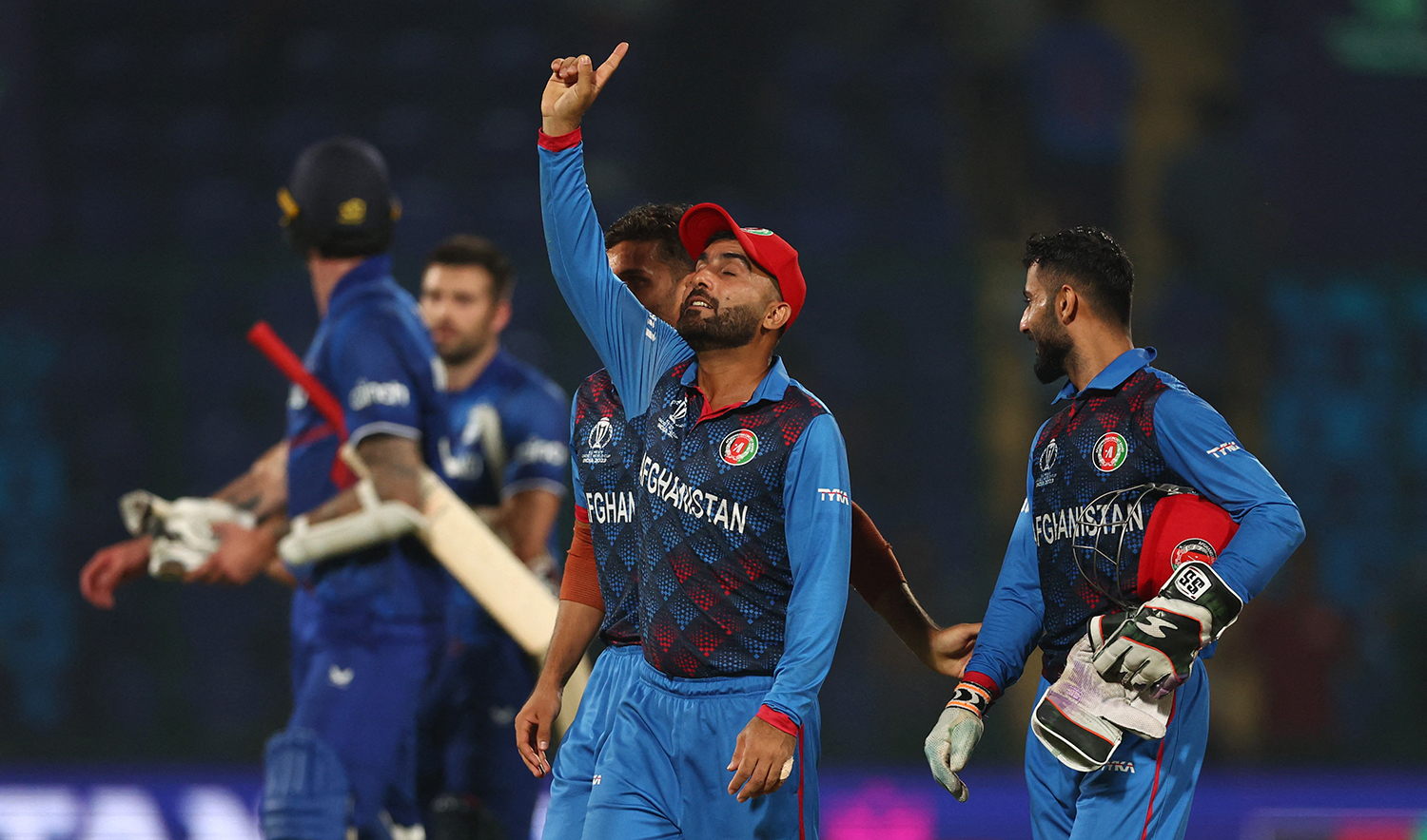 Afghanistan players celebrate after defeating England in a ICC Cricket World Cup 2023 match at Arun Jaitley Stadium in New Delhi, India on October 15, 2023. (REUTERS)