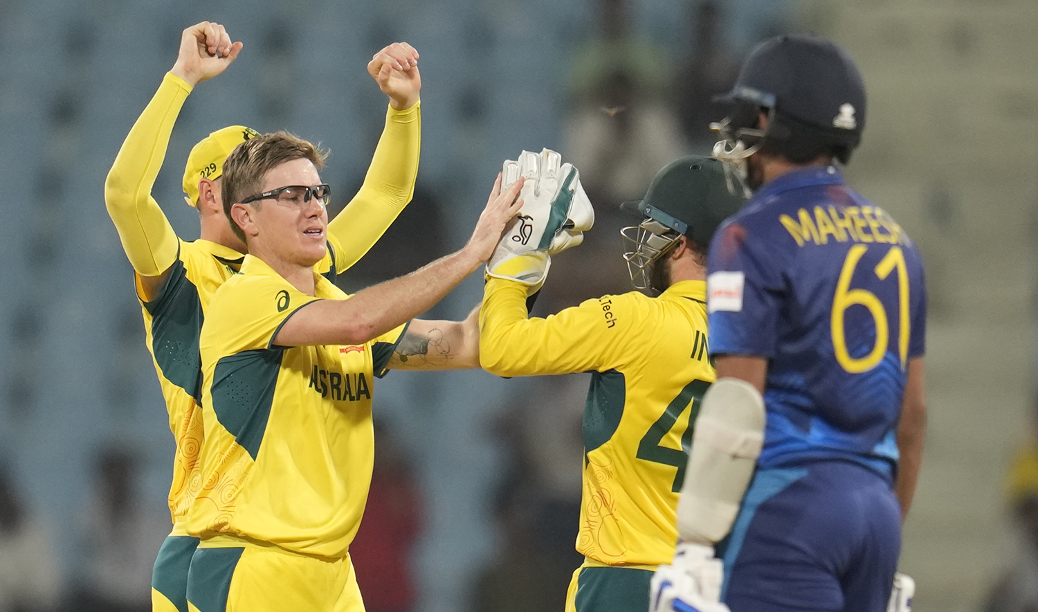 Australia's Adam Zampa celebrates the wicket of Sri Lanka's Maheesh Theekshana, right, during the ICC Men's Cricket World Cup match in Lucknow, India, on October 16, 2023. (AP)