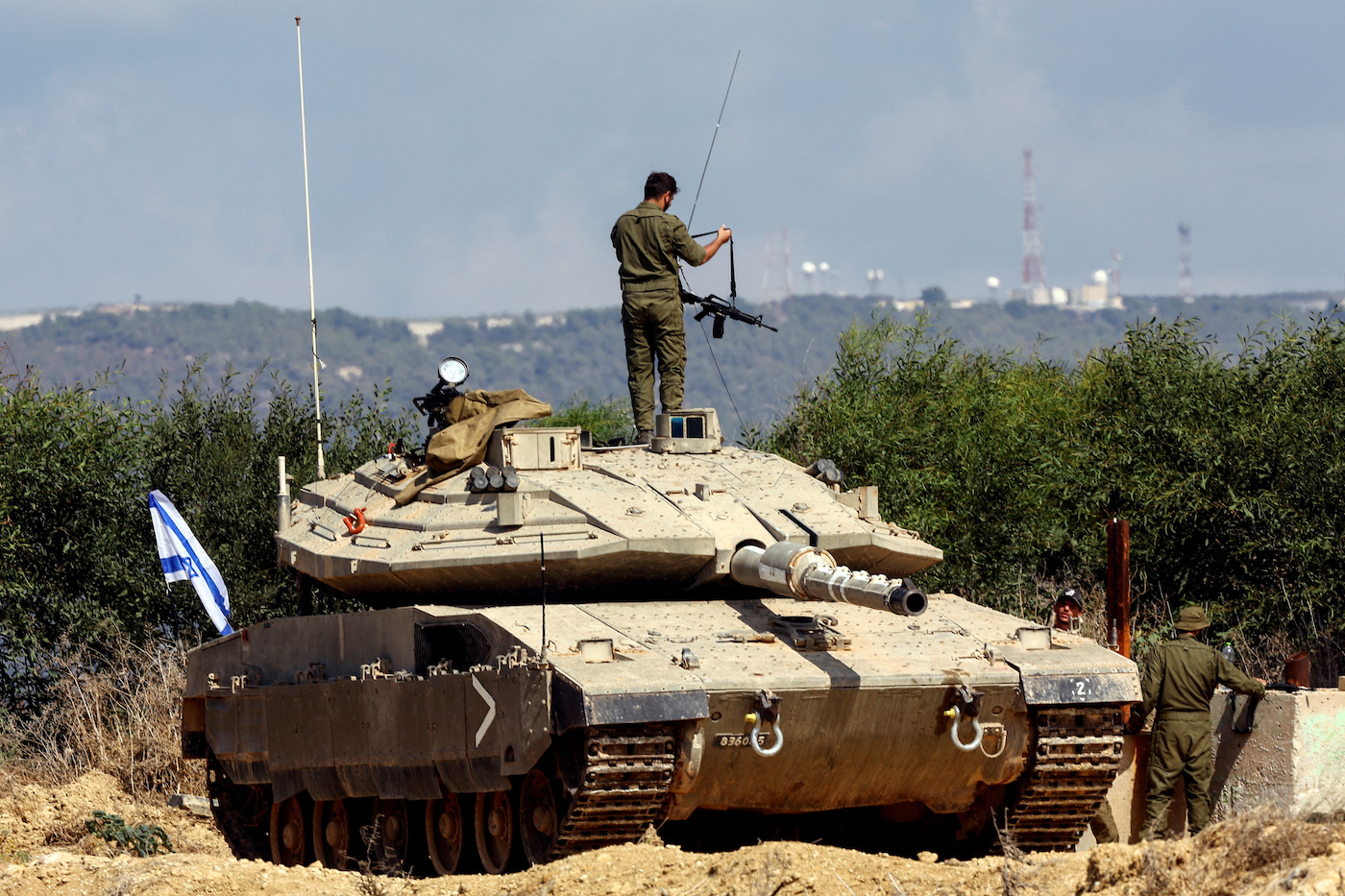 An Israeli soldier adjusts his rifle as he stands on a tank near Israel’s border with Lebanon in northern Israel. (File/Reuters)