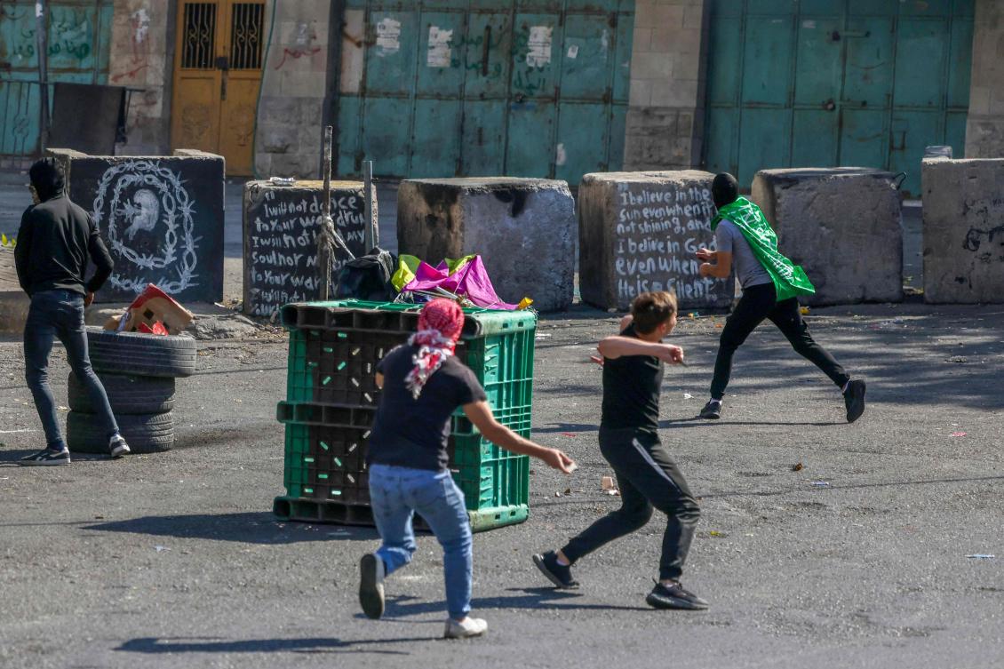 Palestinian demonstrators clash with Israeli security forces in the occupied West Bank city of Hebron on Oct. 18, 2023, following a strike which ripped through a Gaza hospital compound killing hundreds on Oct. 17, 2023. (AFP)