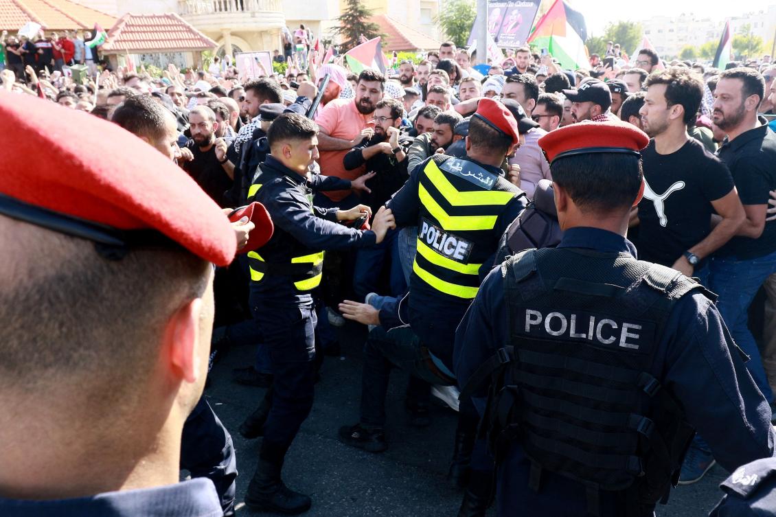 Protesters scuffle with Jordanian police near the Israeli Embassy in Amman on October 18, 2023, as they demonstrate against the killing of hundreds of Palestinians following a strike on a hospital in the Gaza Strip. (AFP)
