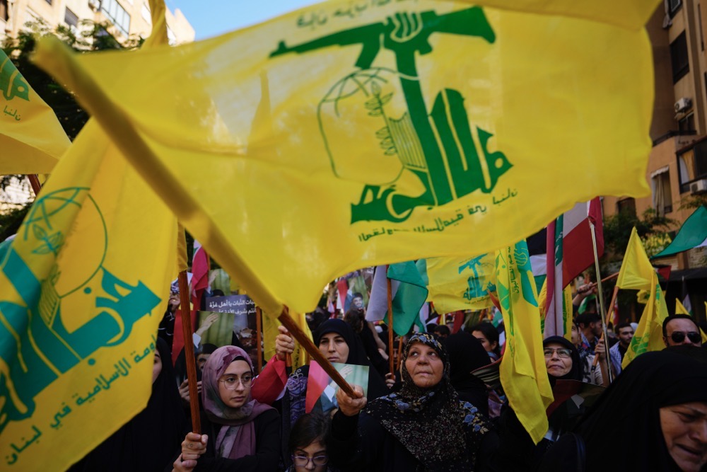 Hezbollah supporters wave Hezbollah flags during a protest in solidarity with the Palestinian people in Gaza, in the southern suburb of Beirut, Lebanon, Wednesday, Oct. 18, 2023. (AP)