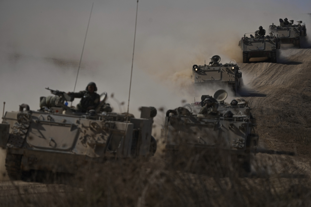 Israeli APCs head toward the Gaza Strip border in southern Israel. (AP)