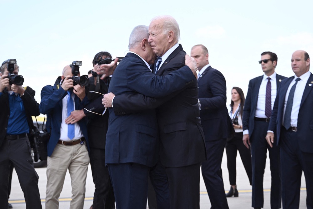Israel Prime Minister Benjamin Netanyahu (L) hugs US President Joe Biden upon his arrival at Tel Aviv's Ben Gurion airport. (AFP)