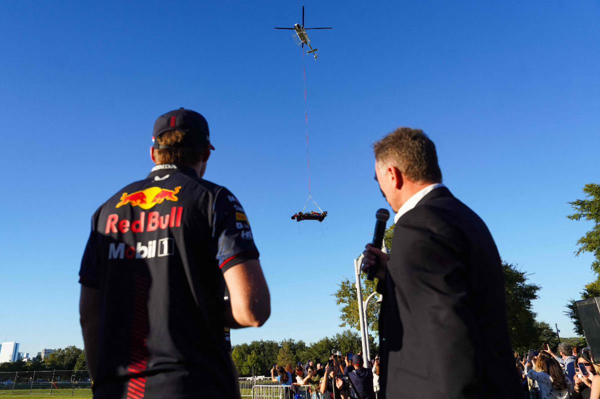 Max Verstappen of the Netherlands and Oracle Red Bull Racing and team principal Christian Horner look on as the Oracle Red Bull Racing car is delivered by helicopter during the Make Your Mark livery reveal event at Oracle HQ on Wednesday in Austin, Texas. (Getty Images/AFP)