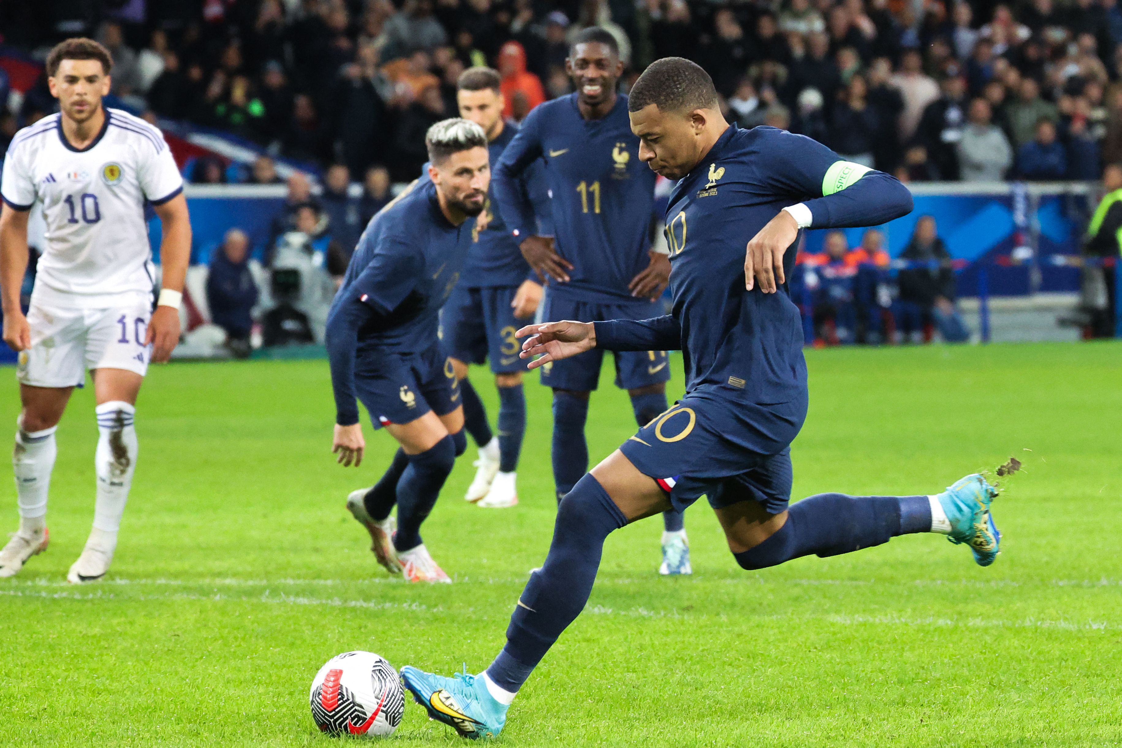 France's forward Kylian Mbappe shoots and scores his team's third goal on a penalty during the friendly football match between France and Scotland at Pierre-Mauroy stadium, in Villeneuve-D'Ascq, northern France, on Tuesday. (AFP)
