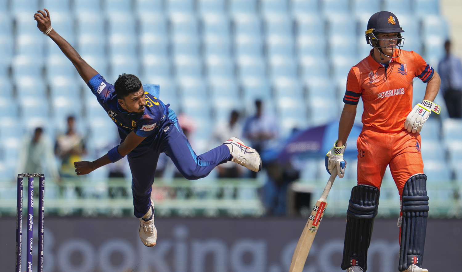 Sri Lanka's Dilshan Madushanka bowls as Netherlands' Teja Nidamanuru watches on during the ICC Men's Cricket World Cup match between Sri Lanka and Netherlands in Lucknow, India, on October 21, 2023. (AP)