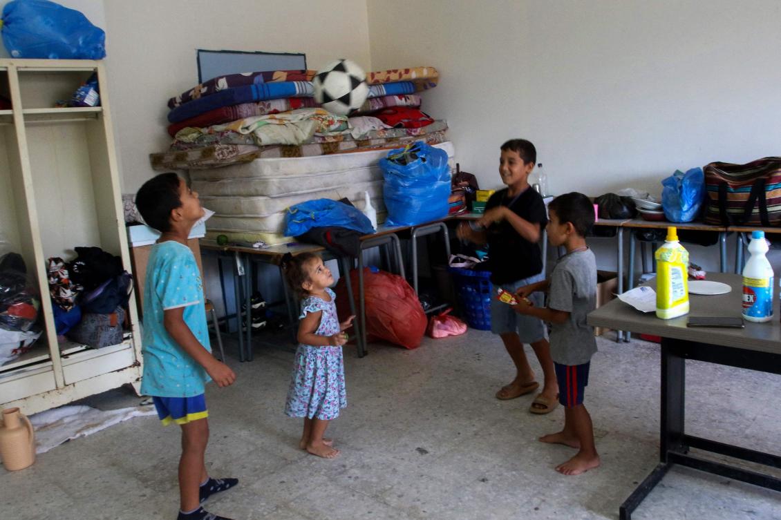 Children from Beit Leef village play footall in a classroom of a school where displaced Lebanese families from villages near the southern border took refuge in Tyre city, on October 19, 2023. (AFP)
