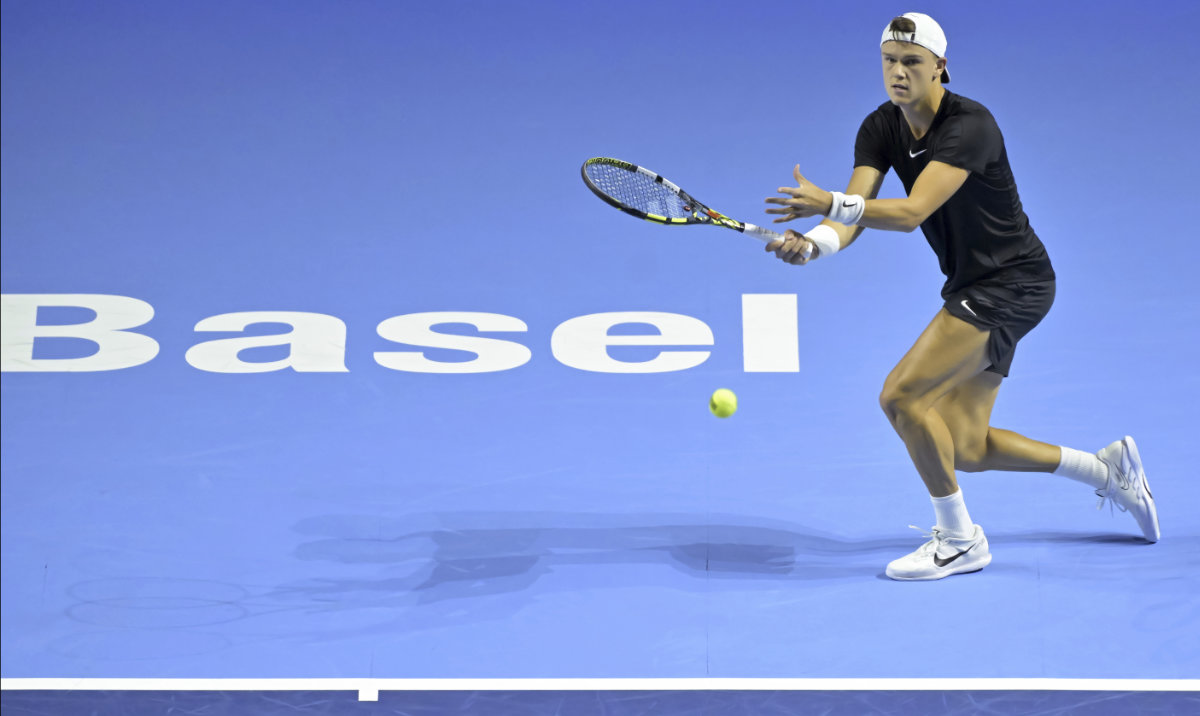 Denmark's Holger Rune returns a ball to Serbia's Miomir Kecmanovic during their first round match at the Swiss Indoors tennis tournament at the St. Jakobshalle in Basel, Switzerland, on Tuesday. (AP)