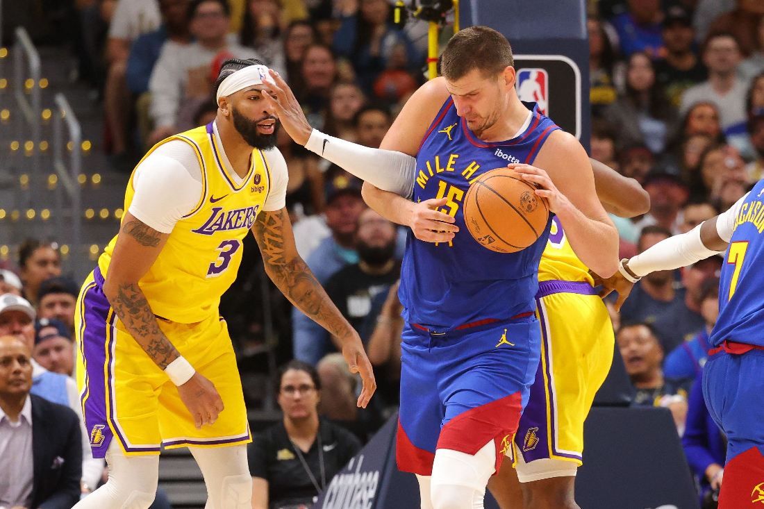 Nikola Jokic of the Denver Nuggets fights for a rebound against the Los Angeles Lakers in the second half of the NBA Opening night game at Ball Arena. (AFP)