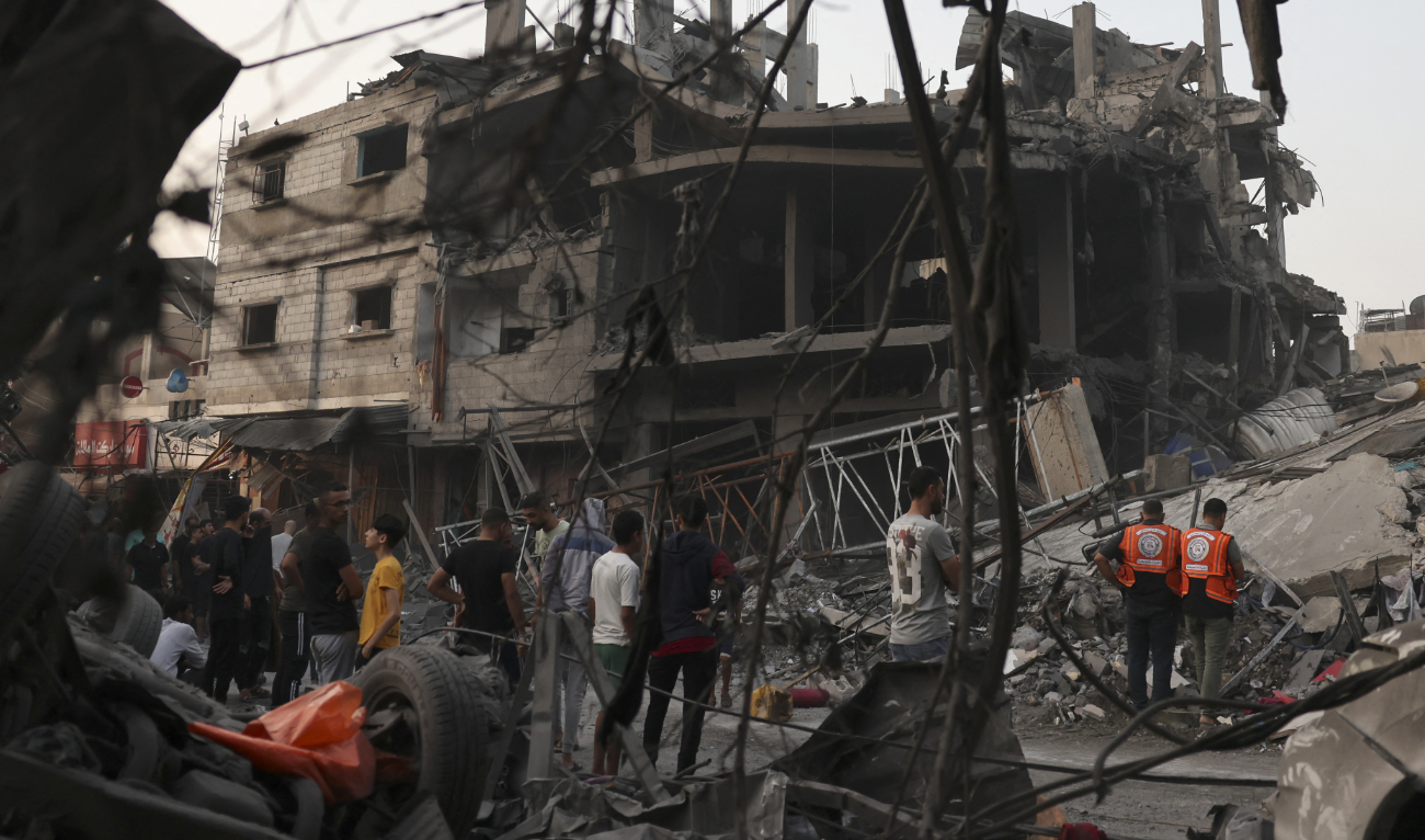 Palestinians inspect the rubble of a building following overnight Israeli strikes on the Rafah refugee camp in the southern Gaza Strip on October 25, 2023. (AFP)