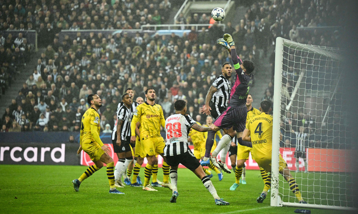 Dortmund's Swiss goalkeeper #01 Gregor Kobel jumps to save the ball during the UEFA Champions League Group F football match between Newcastle United and Borussia Dortmund at St James' Park in Newcastle-upon-Tyne, north east England, on October 25, 2023. (AFP)