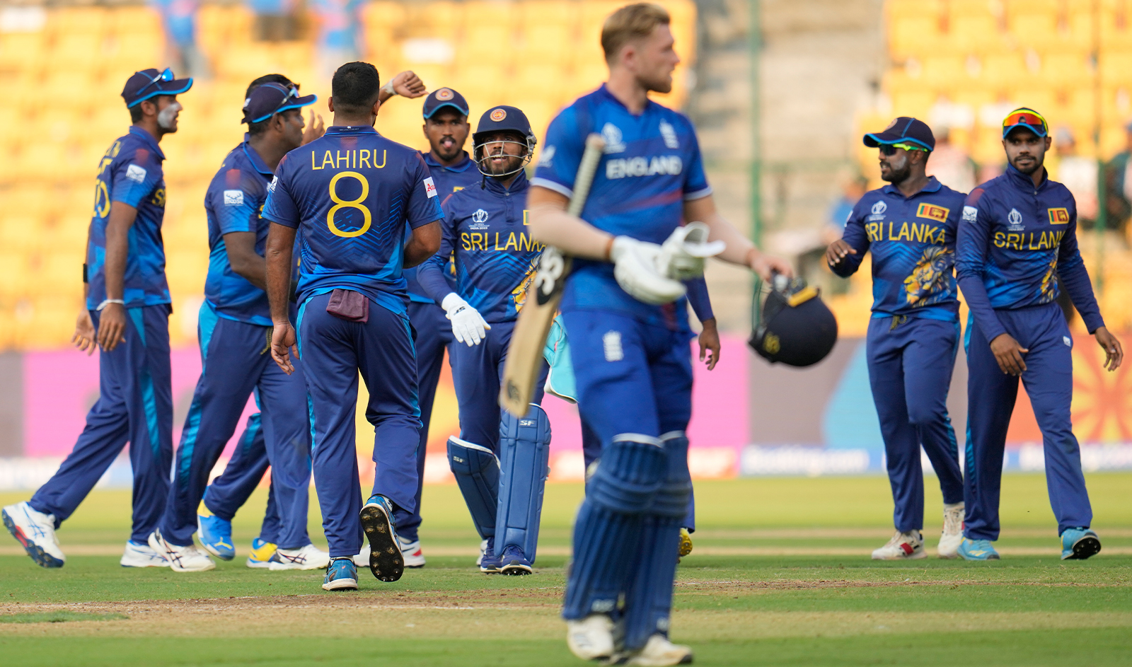 Sri Lankan players celebrate the wicket of England's Mark Wood with his teammates during the ICC Men's Cricket World Cup match between England and Sri Lanka in Bengaluru, India, on October 26, 2023. (AP)