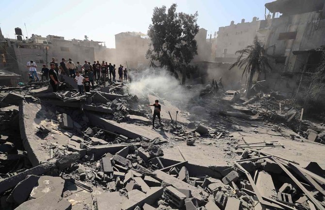 Palestinians search for survivors and the bodies in the rubble of buildings destroyed during Israeli bombardment, in Khan Yunis in southern Gaza Strip on October 26, 2023. (AFP)