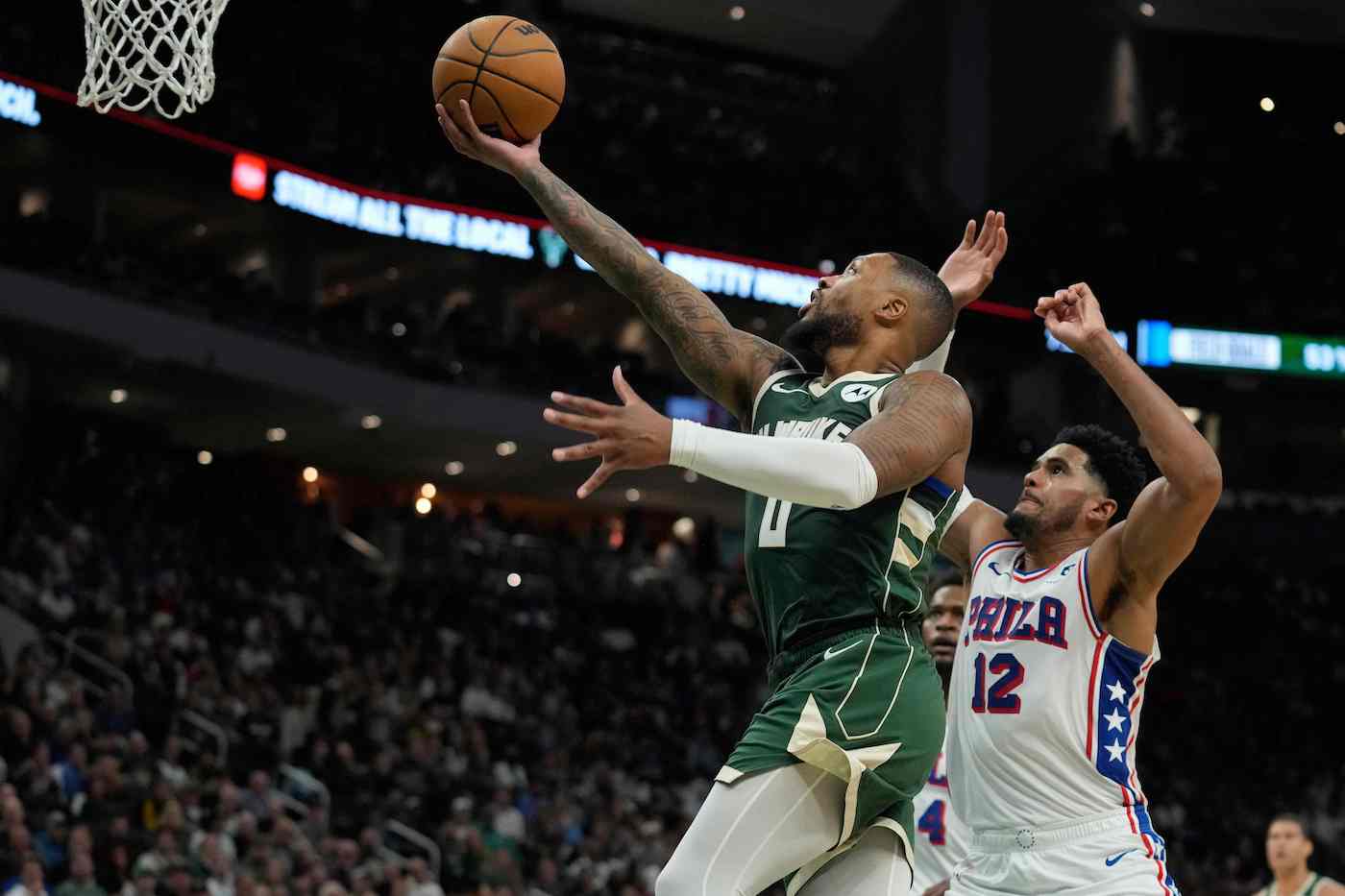 Damian Lillard of the Milwaukee Bucks shoots the ball against Tobias Harris of the Philadelphia 76ers during their NBA game at Fiserv Forum on Thursday in Milwaukee, Wisconsin. (GETTY IMAGES NORTH AMERICA / AFP)