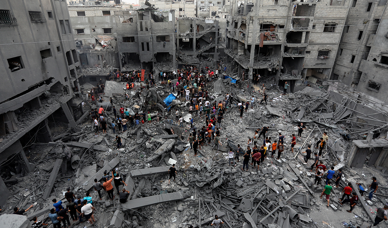 Palestinians inspect the damage of destroyed buildings following Israeli airstrikes on Gaza City, Friday, Oct. 27, 2023. (AP)