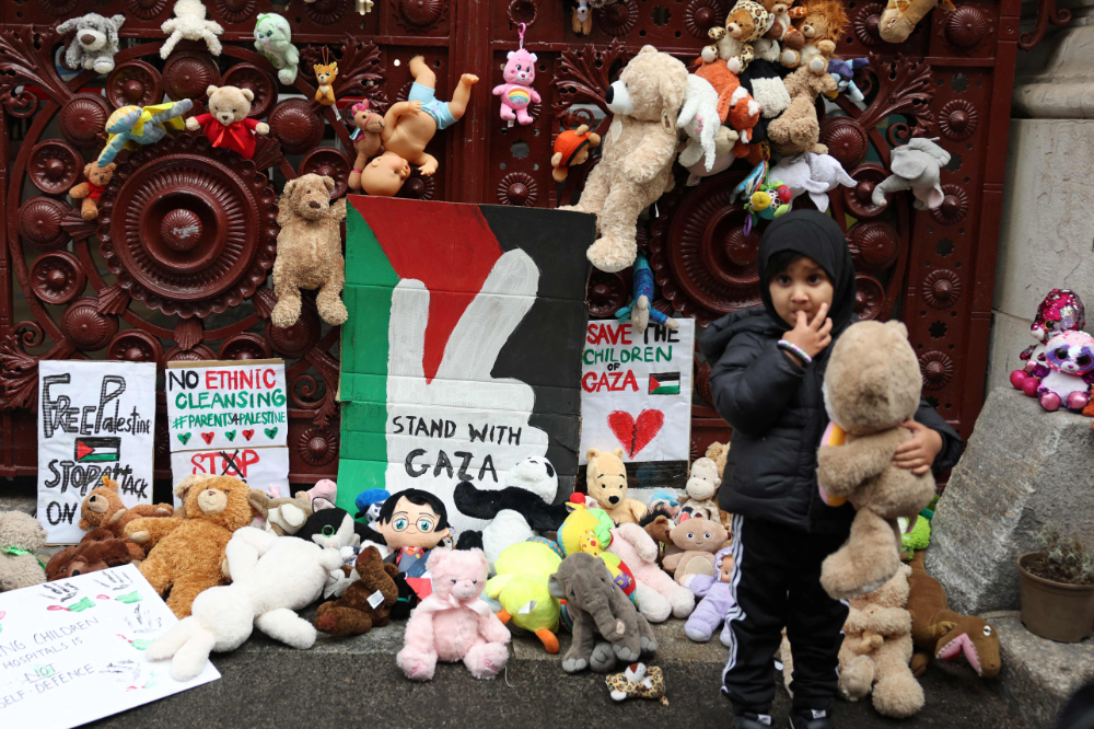 Children bring soft toys representing children killed in Gaza to the gates of the Foreign, Commonwealth and Development Office in London. (AFP)