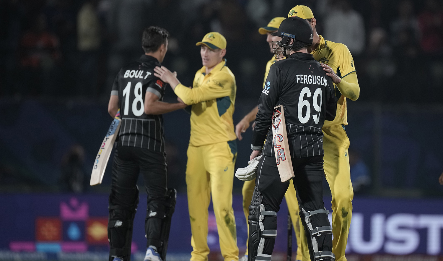 New Zealand's Lockie Ferguson, left, and Trent Boult shake hands with Australian players after they lost the ICC Men's Cricket World Cup match against Australia in Dharamshala, India on October 28, 2023. (AP)