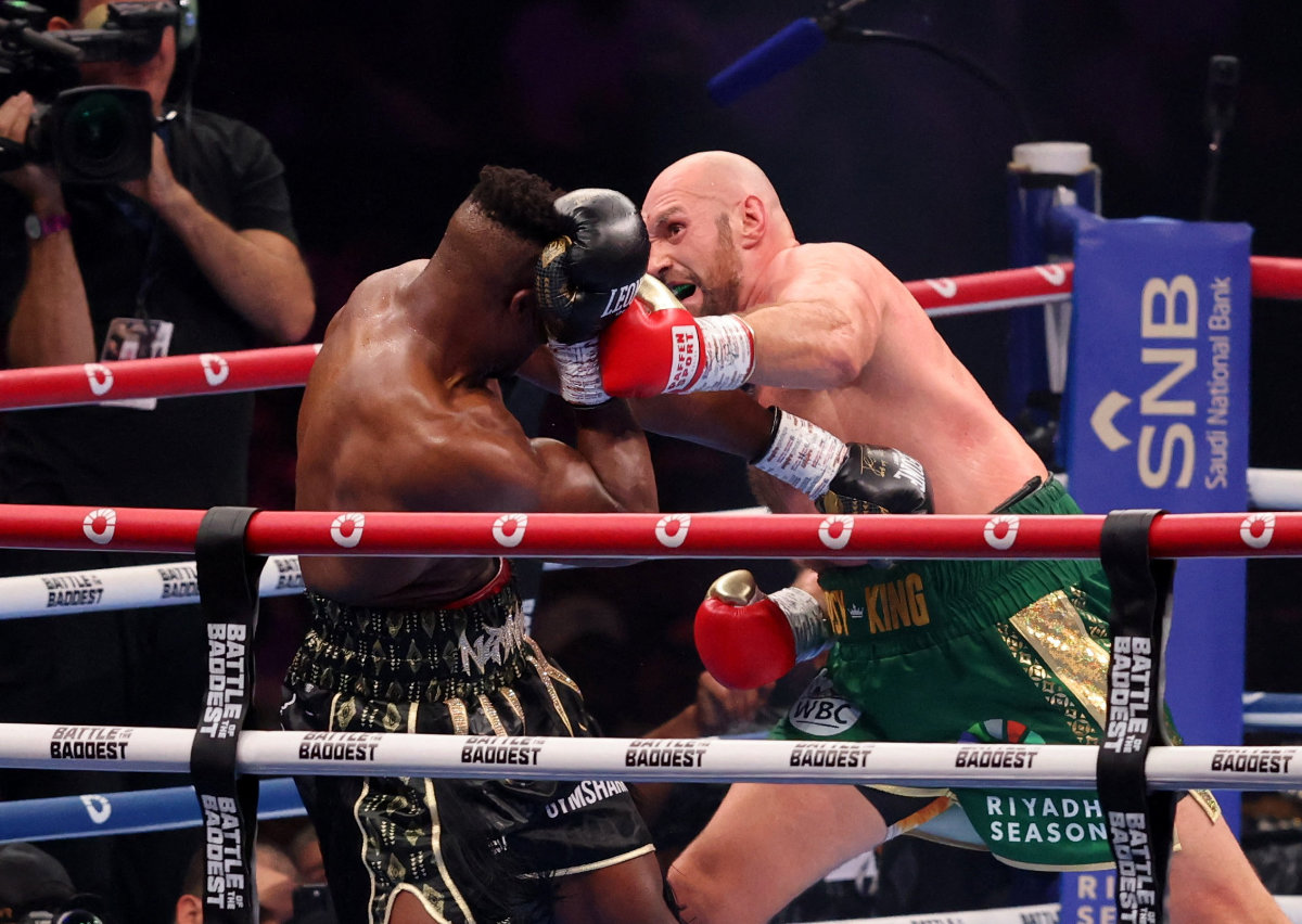 Britain's Tyson Fury (L) falls on the ground as he fights against Cameroonian-French Francis Ngannou during their heavyweight boxing match in Riyadh early on October 29, 2023. (Fayez Nureldine / AFP)