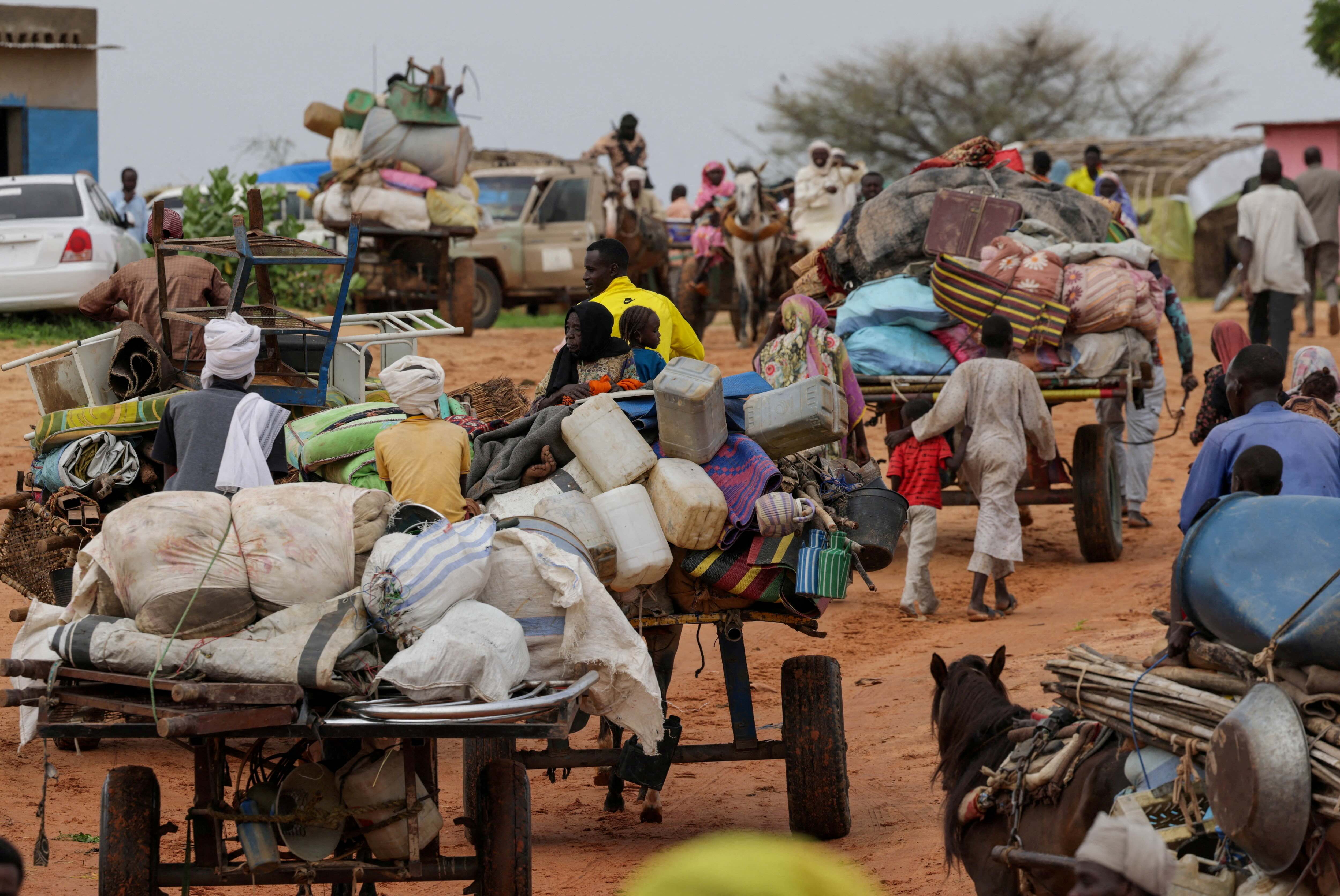 Chadian cart owners transport belongings of Sudanese people who fled the conflict in Sudan’s Darfur region, while crossing the border between Sudan and Chad in Adre. Reuters/File