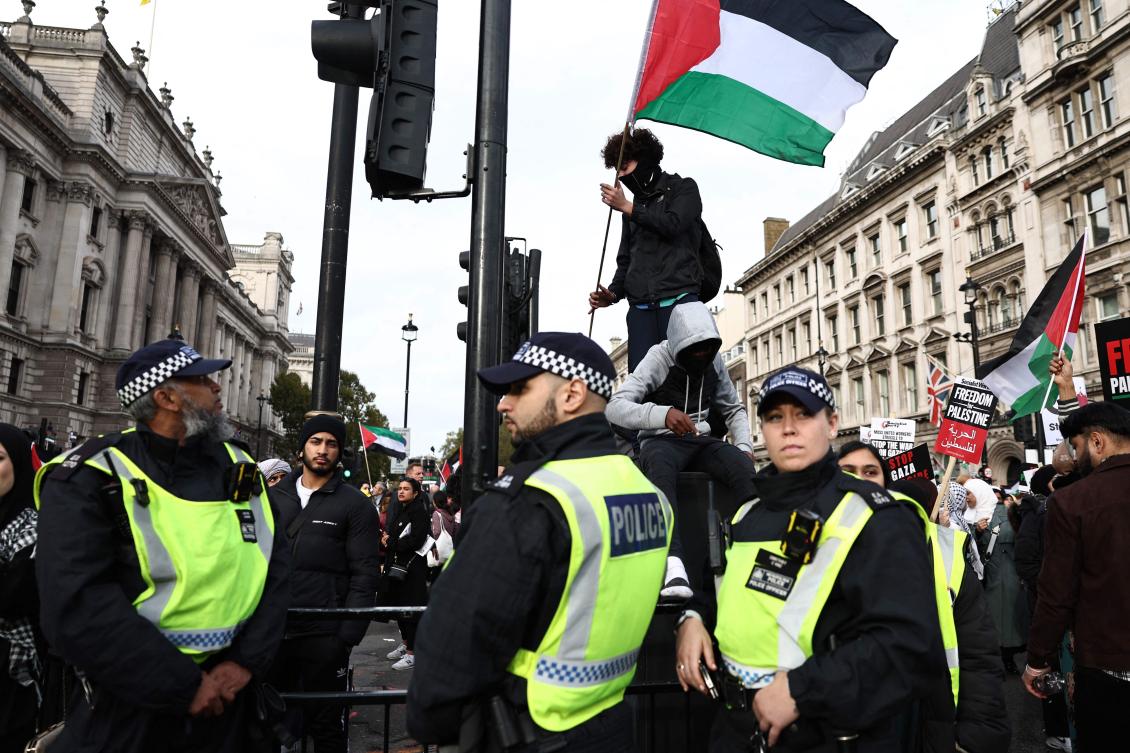 Police officers mingle with the protesters in Parliament Square during the 'March For Palestine' in London on October 28, 2023, to call for a ceasefire in the conflict between Israel and Hamas. (AFP)