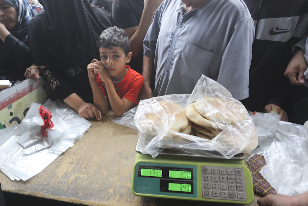 Palestinians wait to buy bread during the ongoing bombardment of the Gaza Strip in Rafah on Sunday, Oct. 29, 2023. (AP)