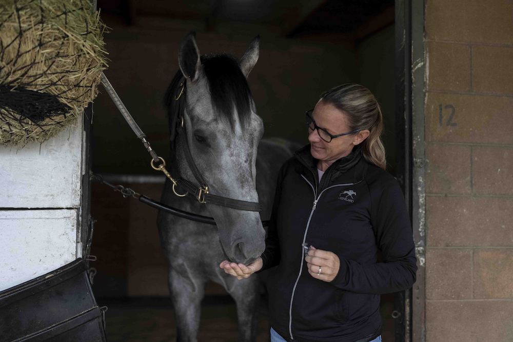 Trainer Jena Antonucci gives a treat to Arcangelo ahead of the Breeders’ Cup horse race at Santa Anita Park in Arcadia, Calif., Friday. (AP)