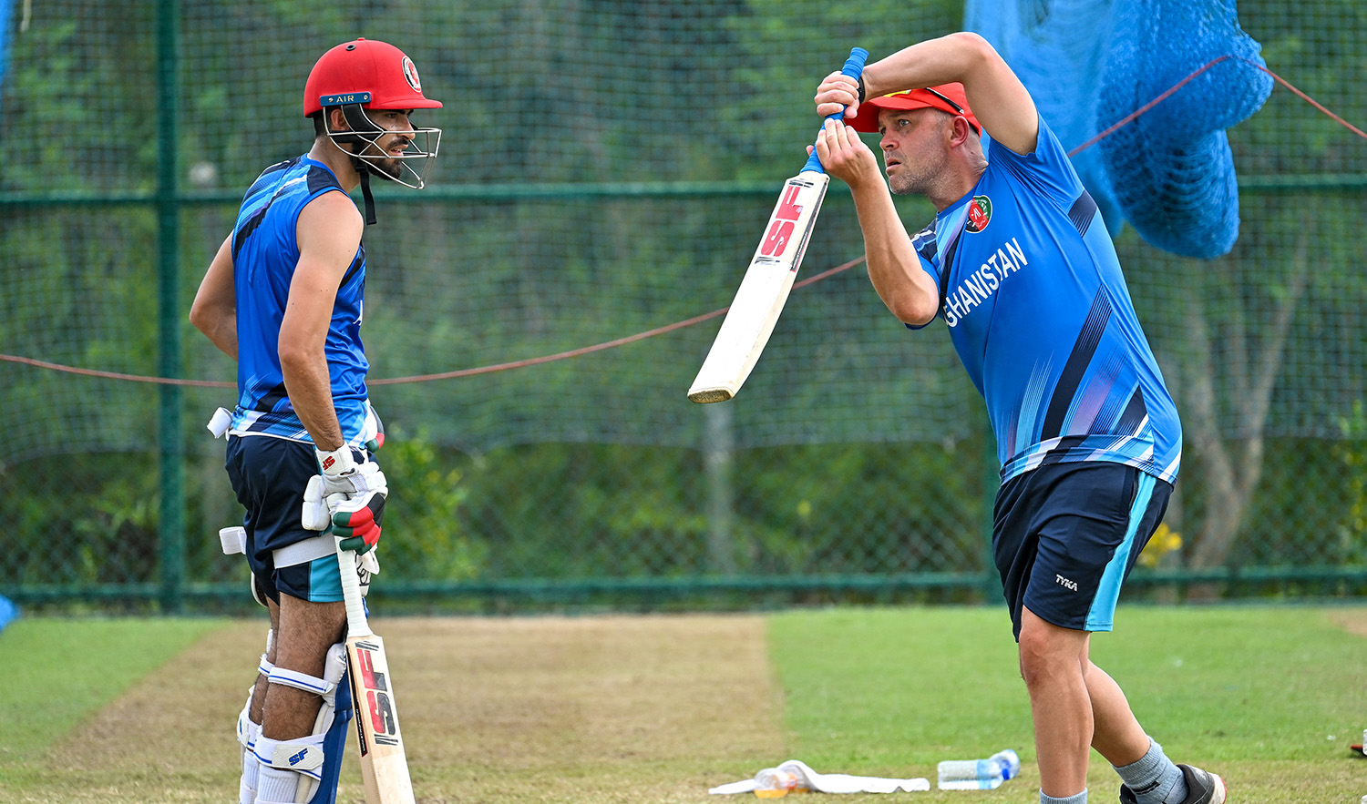 Afghanistan's coach Jonathan Trott (R) and Ibrahim Zadran attend a practice session at the Mahinda Rajapaksa International Cricket Stadium in Hambantota on June 1, 2023. (AFP/File)