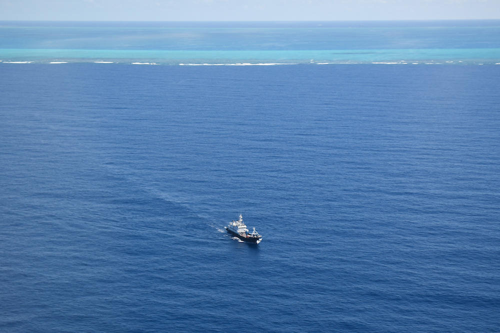 Above, a Chinese naval militia vessel patrols near the Chinese-controlled Scarborough Shoal in this phot taken on Sept. 28, 2023. (AFP)